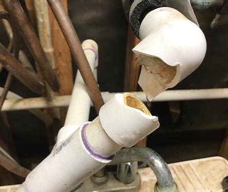 busted plumbing pvc water pipe with ice frozen