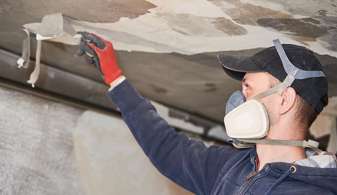 Professional expert removing smoke soot from the ceiling