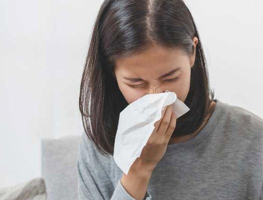 An allergic person sneezing